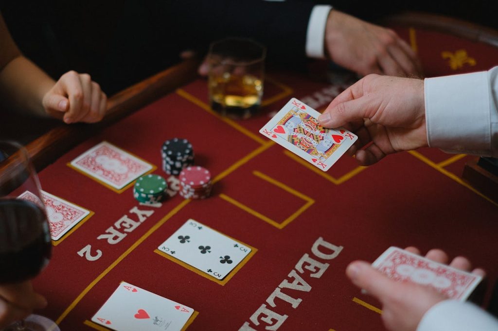 A Person Holding King of Hearts Card